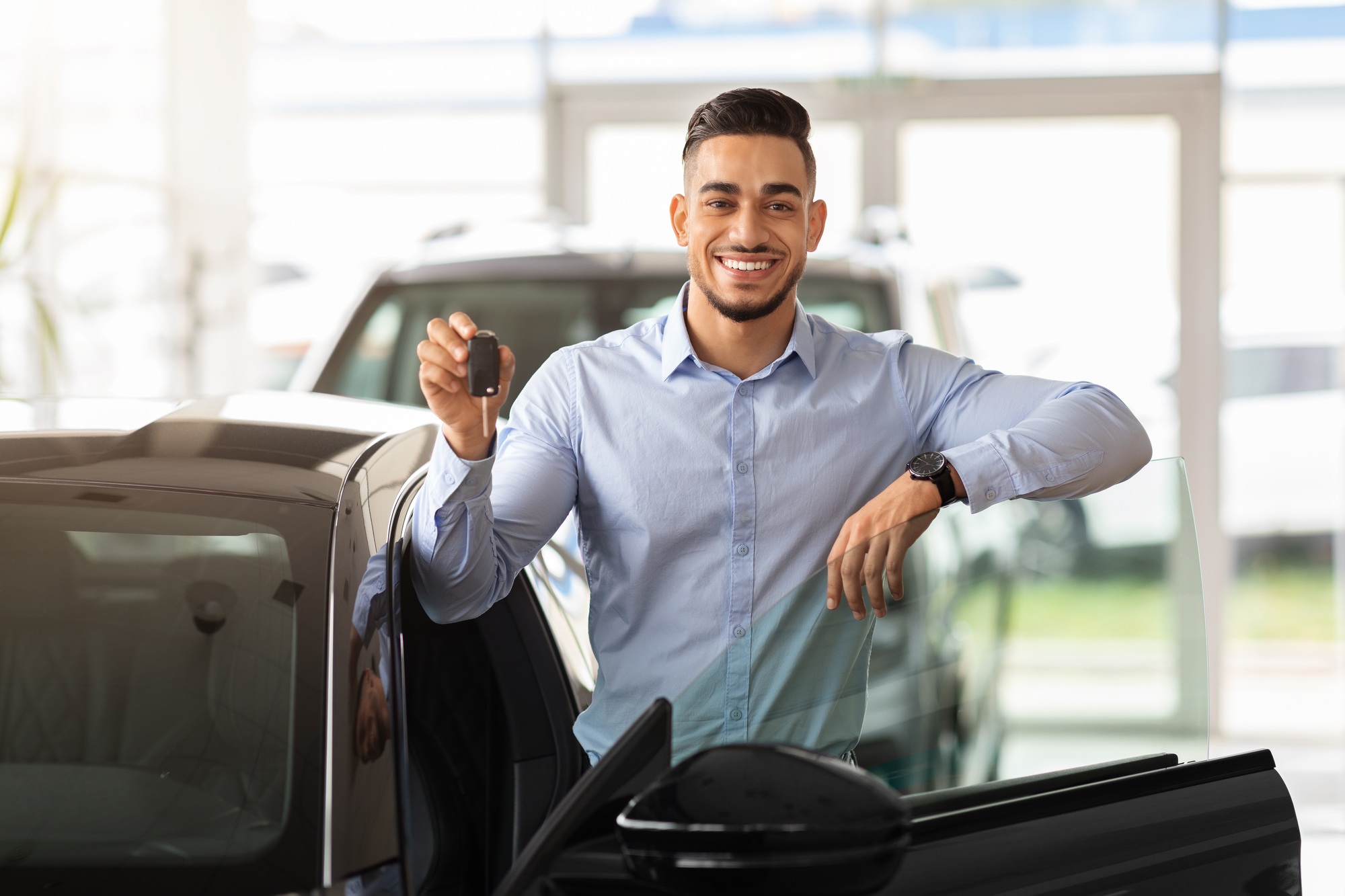 Successful middle-eastern businessman buying new sports car